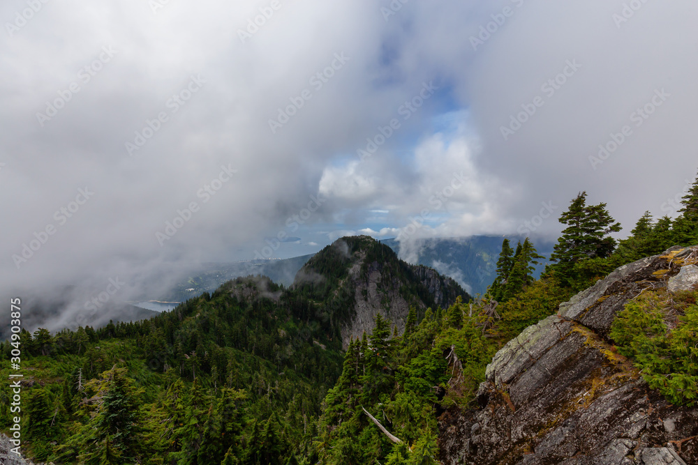 Beautiful View of Canadian Mountain Landscape during a cloudy summer morning. Taken on Crown Mountain, North Vancouver, British Columbia, Canada.