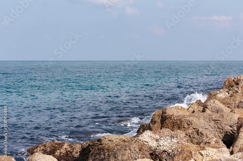 Stones and blue sea water as background