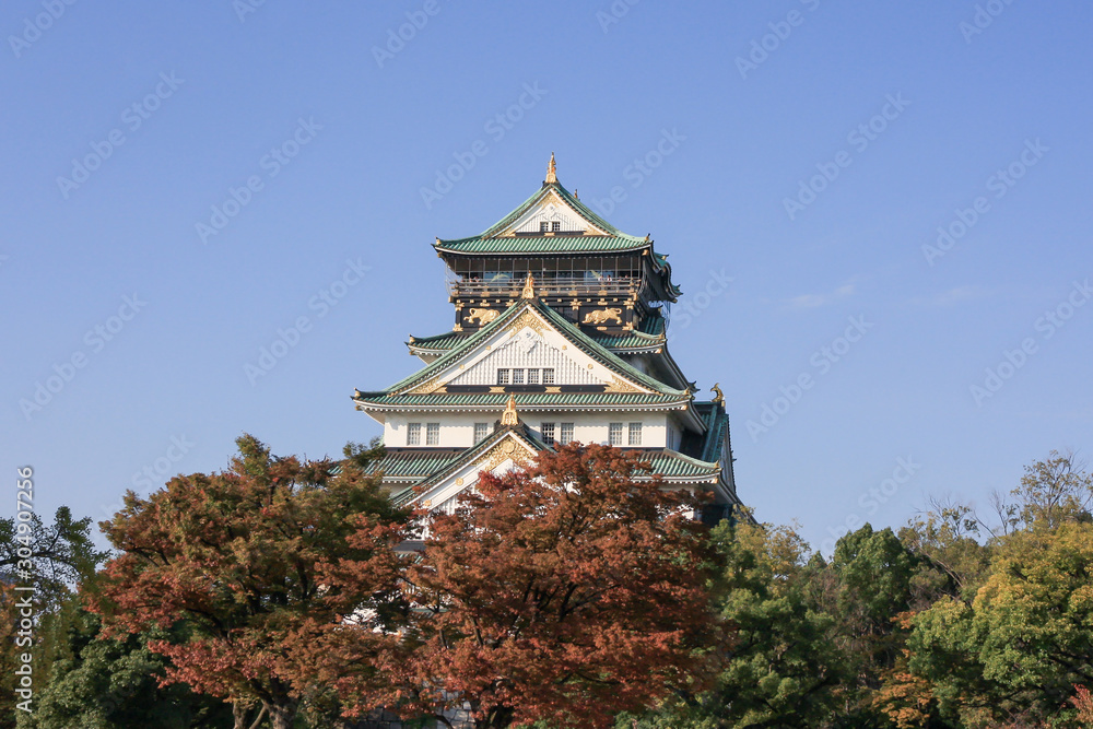 Beautiful view of the Osaka Castle in Osaka city with foliage leaves in autumn season. Beautiful view of the Osaka Castle in Osaka city with foliage leaves in autumn season.