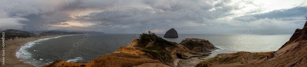 Cape Kiwanda, Pacific City, Oregon Coast, United States of America. Beautiful Panoramic Landscape View of a Sandy Shore on the Ocean during a cloudy summer sunset.