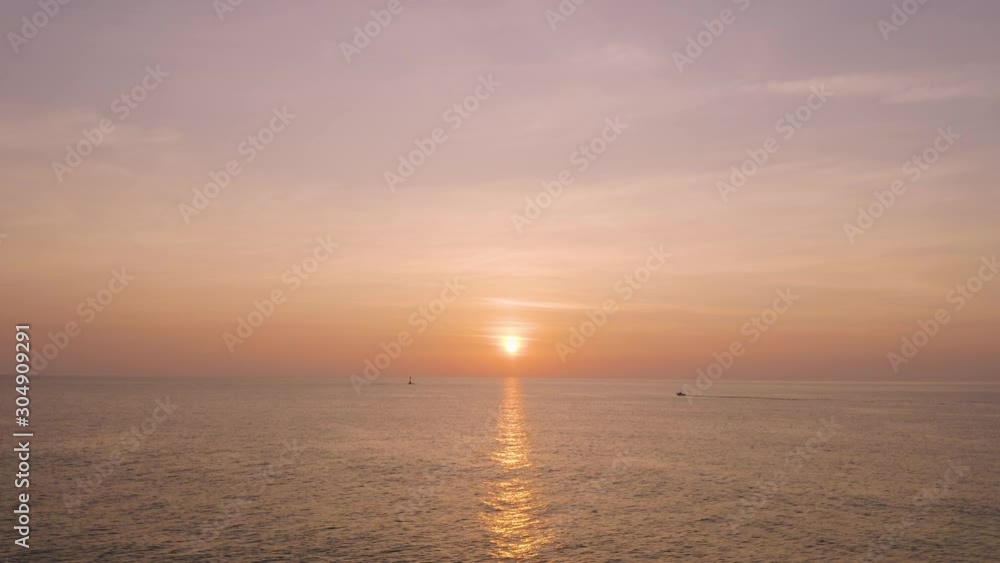 Aerial view of sunrise and fishing boat over the sea Aerial view of sunrise and fishing boat over the sea