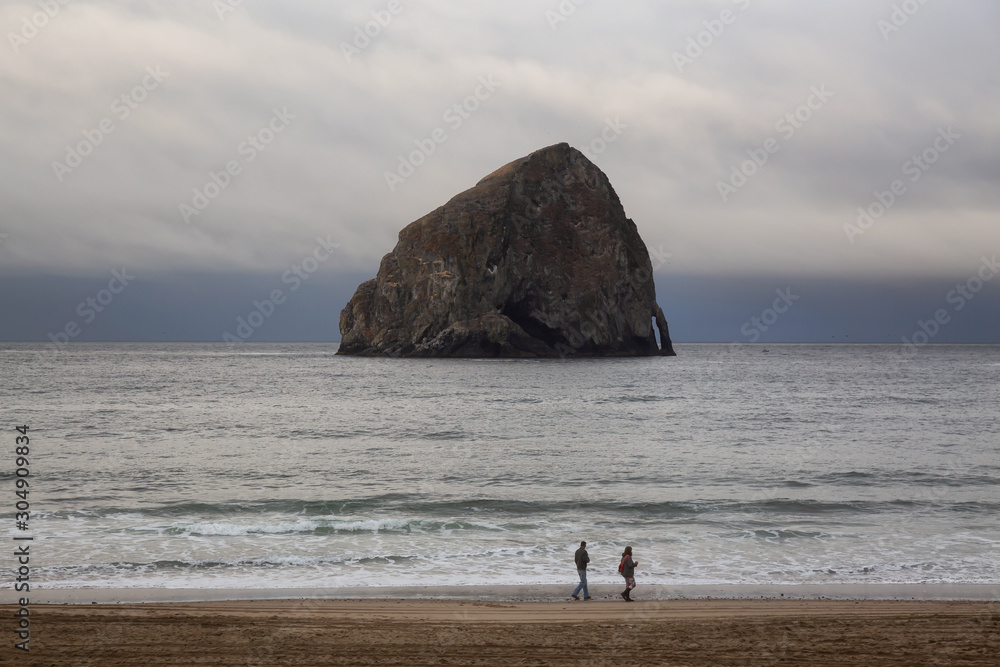 Pacific City, Oregon, United States of America. Beautiful View of Chief Kiawanda Rock on the Ocean Coast during a cloudy summer sunrise.