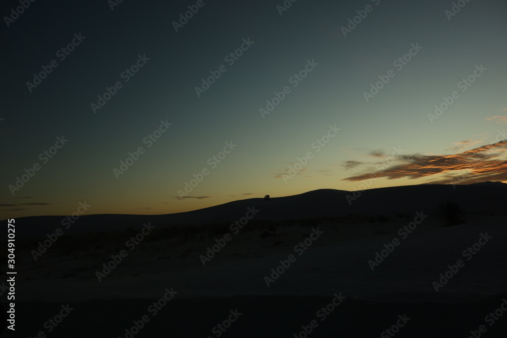 silhouette of the three people on the mountain 