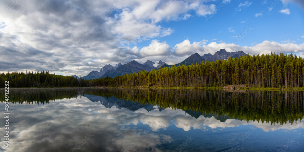 Beautiful Panoramic View of Herbert Lake surrounded by Canadian Rocky Mountain Landscape during a summer sunrise. Taken in  Banff, Alberta, Canada.
