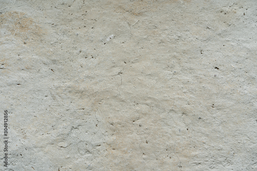 Clay wall background, fragment of an old clay wall with cracks Clay wall background, fragment of an old clay wall with cracks
