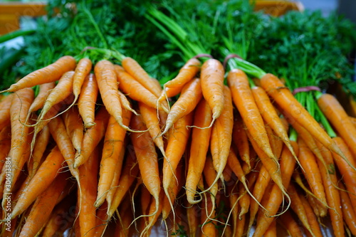 Fresh carrots bunches for sale at a farmers market