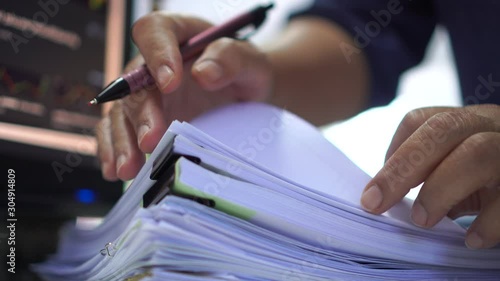 Auditor or businessman checking searching document legal for prepare paperwork or report for analysis information, accountant in workload data contract partner deal in workplace at office, 4k photo