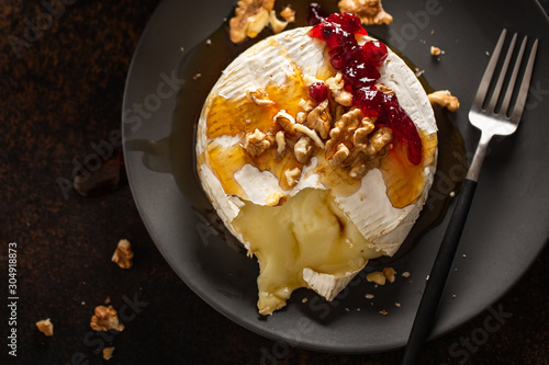 Baked camembert with walnuts and cranberries photo