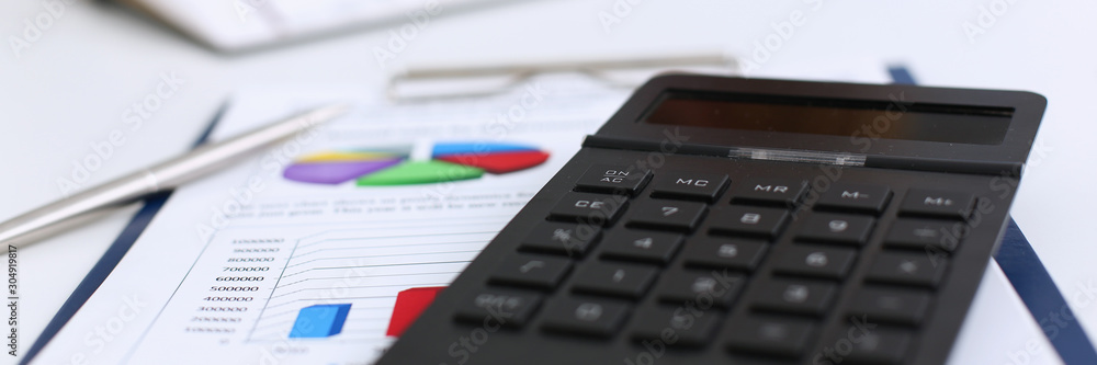 The black calculator lies on a chessboard The black calculator lies on a chessboard
