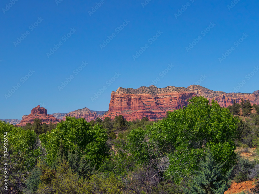 Bell Rock and Courthouse Butte, famous land formations in the Sedona Arizona southwestern United State, scenic desert landscape with a clear blue sky in the spring.