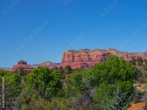 Bell Rock and Courthouse Butte, famous land formations in the Sedona Arizona southwestern United State, scenic desert landscape with a clear blue sky in the spring.