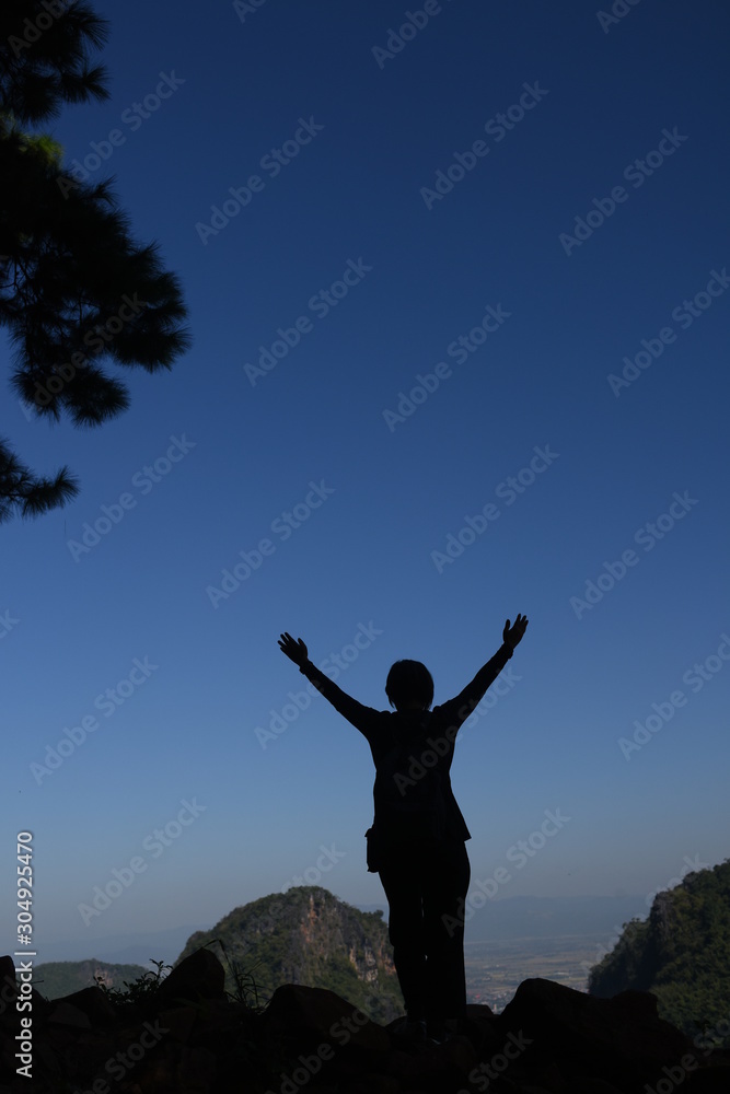 Silhouette of Alone people push arm up over sky in the background