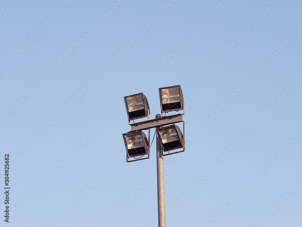 Spotlight for outdoor square shape 4 piece made with steel stick on the pole steel have blue sky background. Spotlight for outdoor square shape 4 piece made with steel stick on the pole steel have blue sky background.