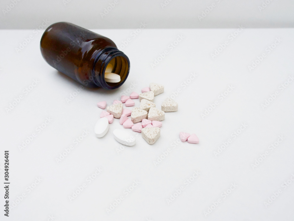 The several pills with the pill bottle are on the white background. The several pills with the pill bottle are on the white background.