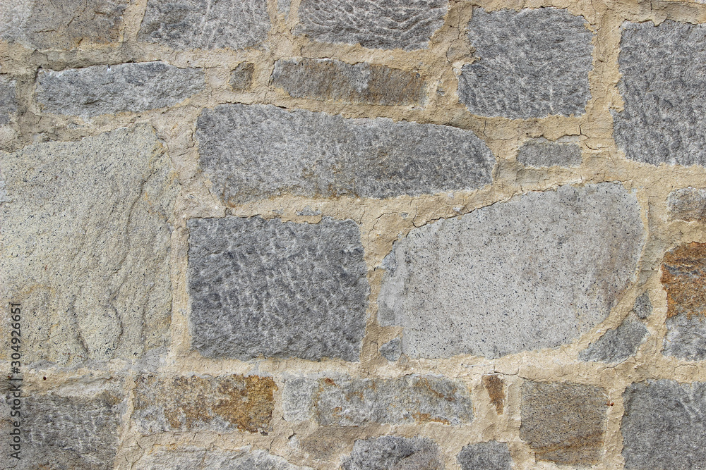 Wall made of natural rocks of different sizes and shapes Wall made of natural rocks of different sizes and shapes