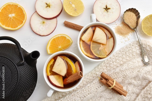 Aromatic fresh fruits tea with apples, lemon, orange and cinnamon.