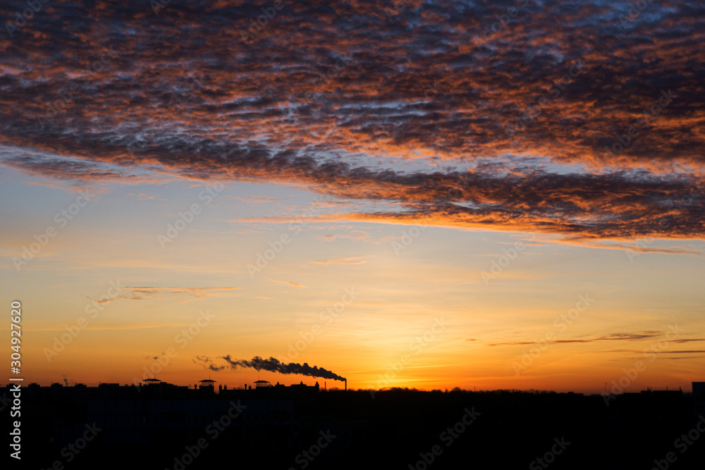 Sunset over city scape. Silhouette City Sunset with dramatic red and ornage sky