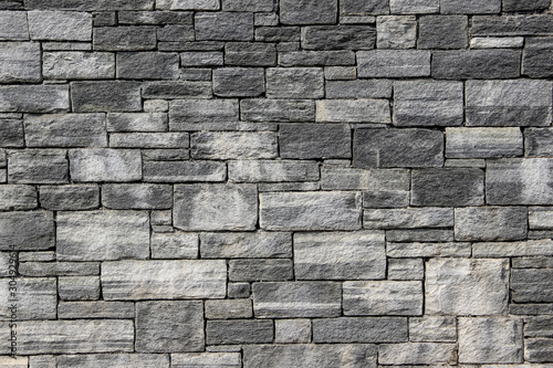 Texture of a wall made of rectangular blocks of different sizes made of natural stones