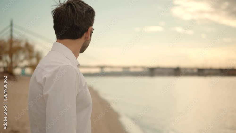 Attractive Man Walking On Sand Beach.Lonely Romantic Guy In Sunglasses Walks On Sand And Dreaming.Man Walking On City Beach.Lonely Handsome Confident Businessmen In Pants Stroll On City Sands Beach. Attractive Man Walking On Sand Beach.Lonely Romantic Guy In Sunglasses Walks On Sand And Dreaming.Man Walking On City Beach.Lonely Handsome Confident Businessmen In Pants Stroll On City Sands Beach.