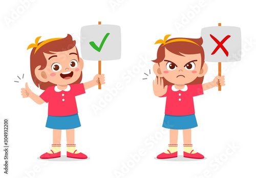 happy cute kid girl with correct and wrong sign