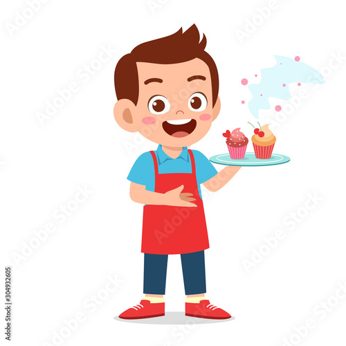 happy cute kid boy try cooking cupcake