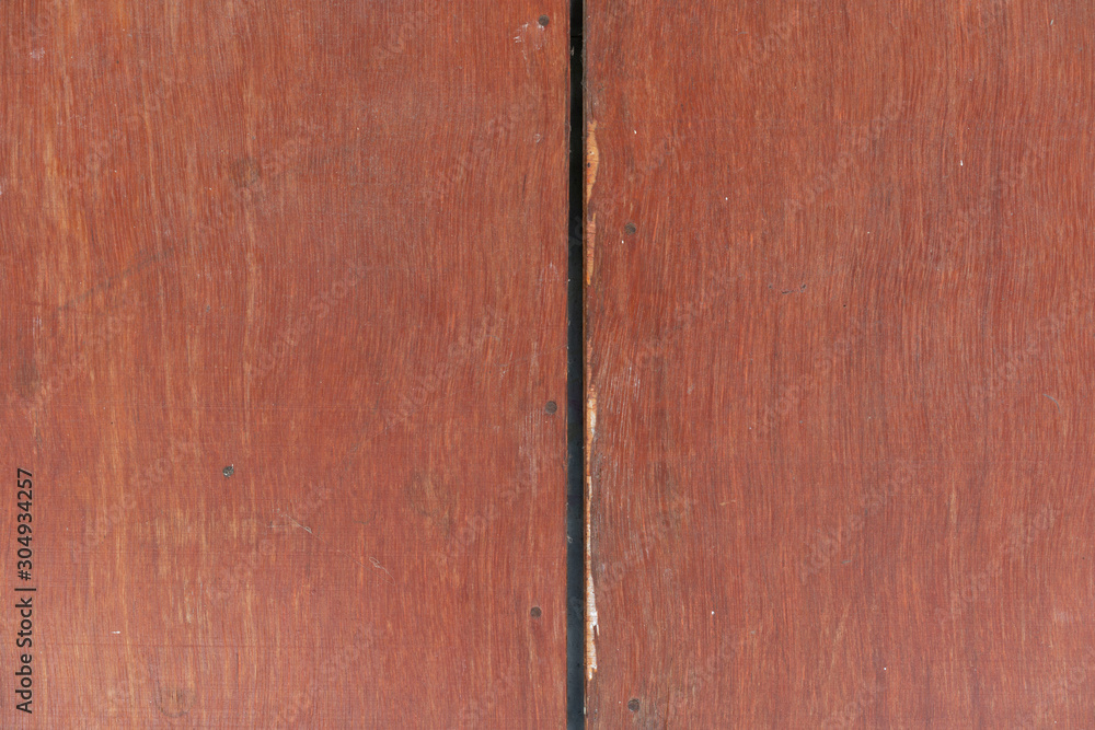 Red wooden texture on door with hole of nails and space in middle Red wooden texture on door with hole of nails and space in middle