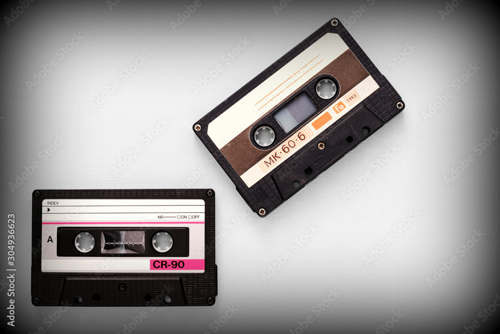 Fototapeta premium Audio tape cassettes on a gray background close-up, top view. Old Technology Concept