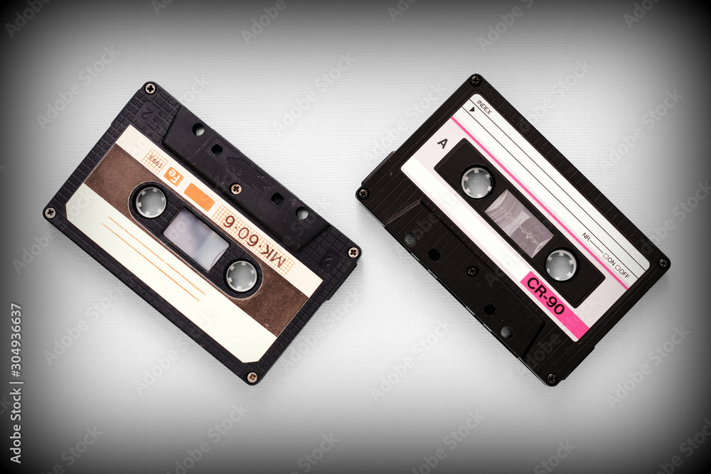 Audio tape cassettes on a gray background close-up, top view. Old Technology Concept Audio tape cassettes on a gray background close-up, top view. Old Technology Concept