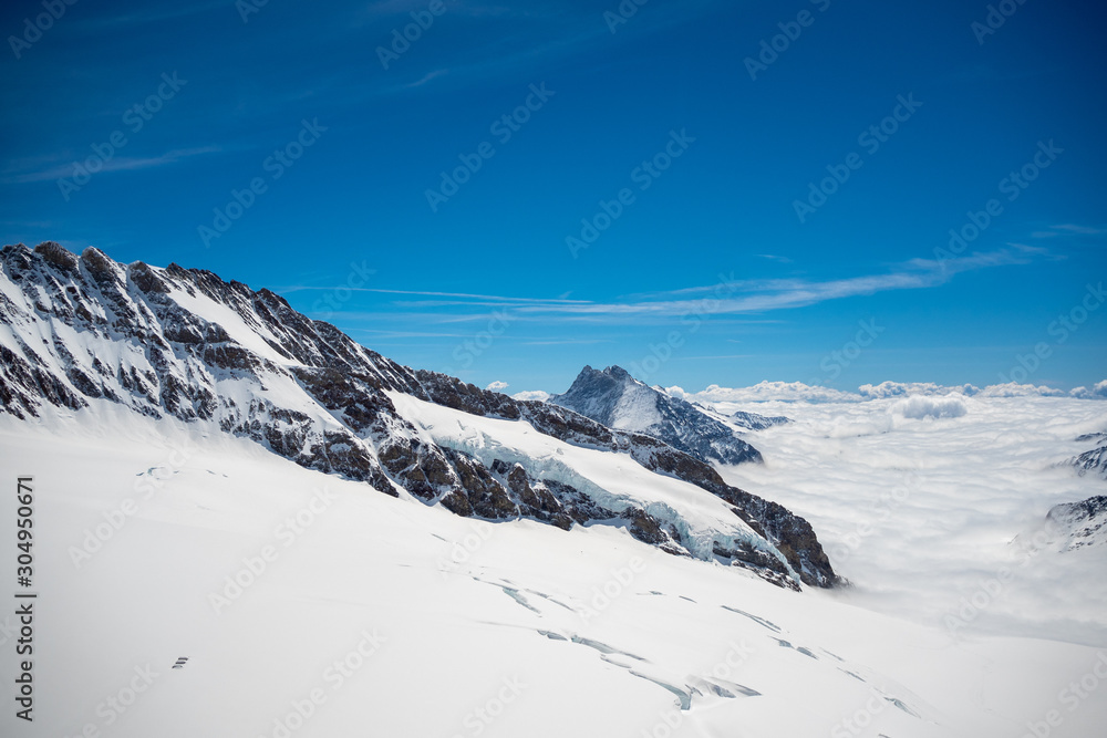Beautiful scene of snow mountain above cloud with clear blue sky, Jungfrau, Switzerland, for background, copy space