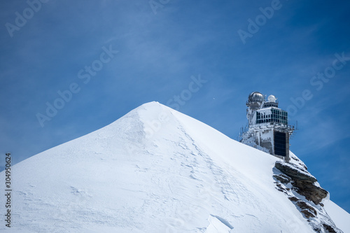 Beautiful scene of Sphnix observation on peak of Jungfrau mountain with clear blue sky, copy space, Switzerland photo