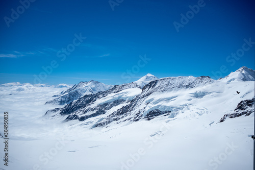 Beautiful view of snow mountain above cloud with clear blue sky looking from viewpoint  Jungfrau  Switzerland  for background  copy space