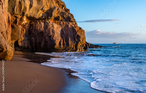 Sunset at sea. Beach in Taurito, Gran Canaria. Ocean and rocks.