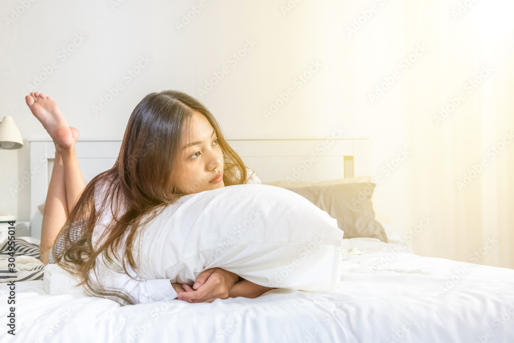 Sleepy young beautiful asian woman wake up unhappy in the morning. Tired attractive teenage girl wake up and lying down on the bed. Sleepy young beautiful asian woman wake up unhappy in the morning. Tired attractive teenage girl wake up and lying down on the bed.
