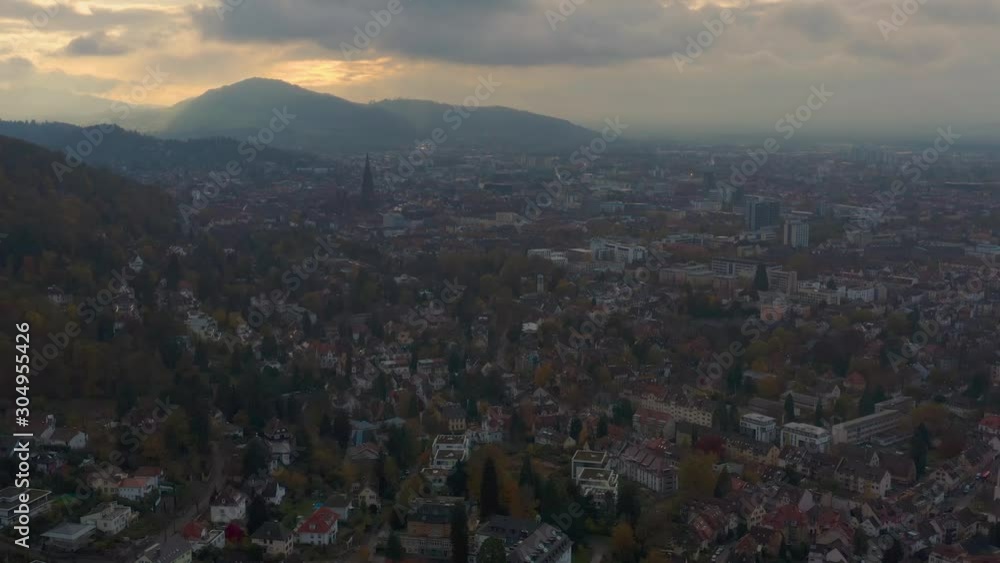 Aerial view around the city Freiburg in Germany on a cloudy day, late afternoon in Autumn in the black forest. Slow ascend with zoom in on the old town. Aerial view around the city Freiburg in Germany on a cloudy day, late afternoon in Autumn in the black forest. Slow ascend with zoom in on the old town.