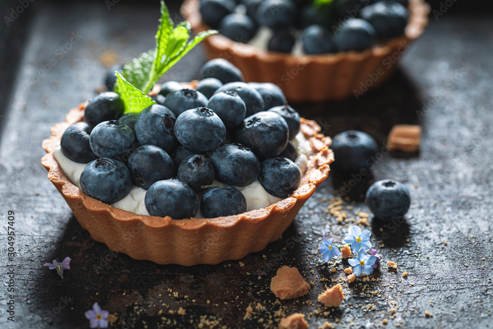 Freshly baked mini tart with blueberries and whipped cream - obrazy, fototapety, plakaty 