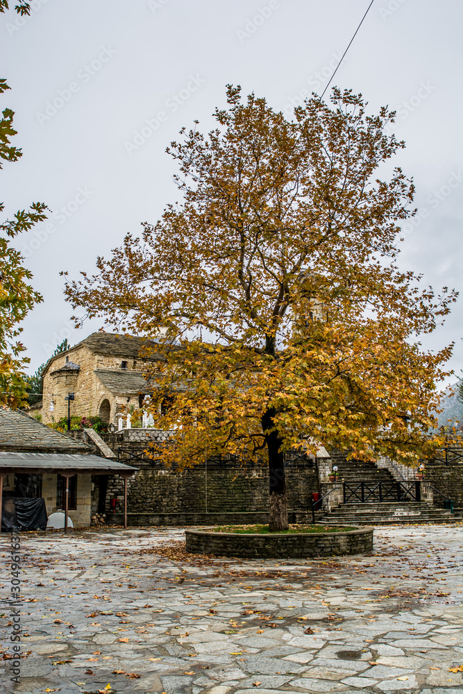 Naklejka premium The beautiful orthodox church of Agia Paraskevi in the square of the village Rodavgi in Tzoumerka , Arta, Greece