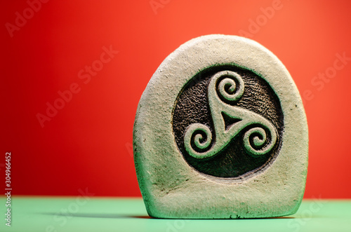 Canvas Print Decorative stone figure with the symbol of a celtic triskele