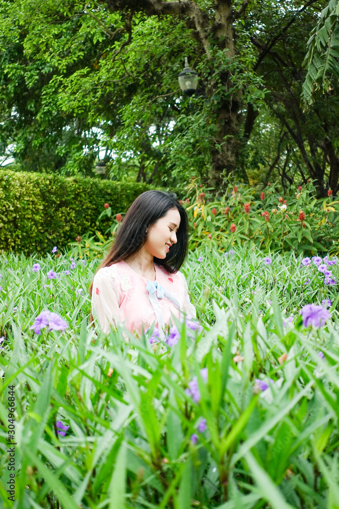 Portrait of beautiful young asian woman relaxing in garden Portrait of beautiful young asian woman relaxing in garden