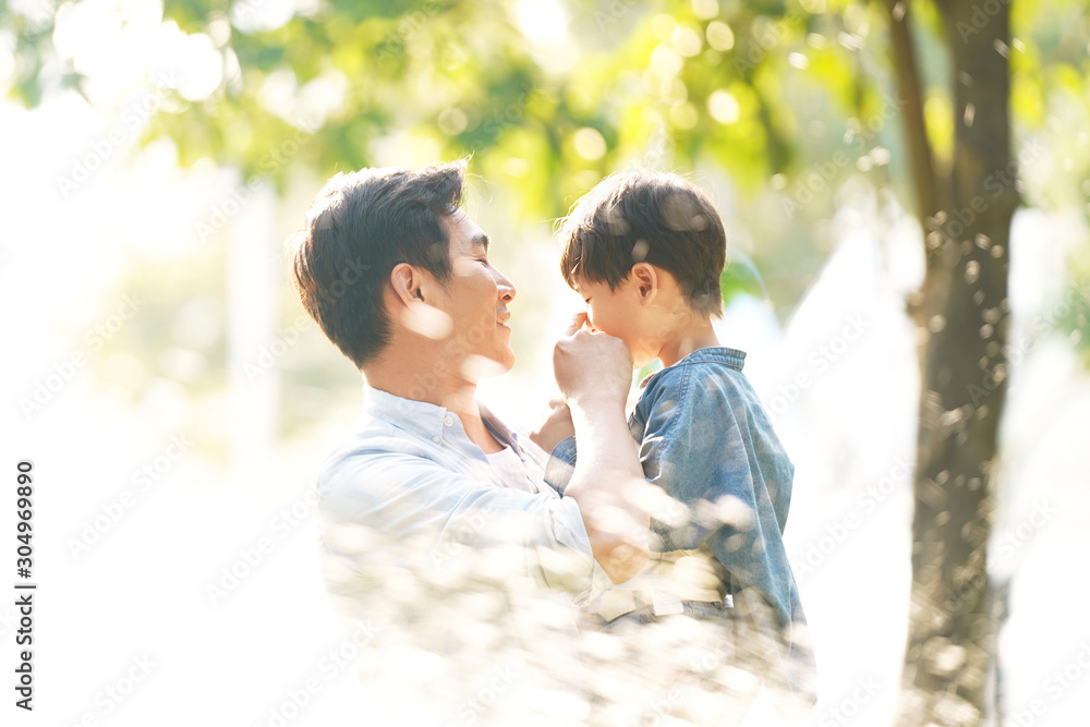 happy asian father and son having fun outdoors happy asian father and son having fun outdoors