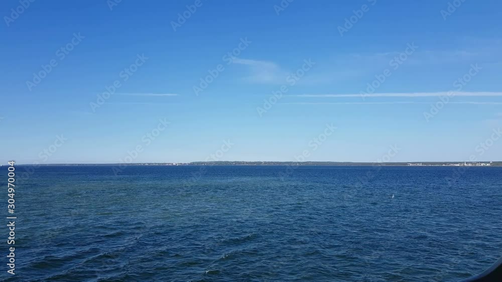 View of the ocean and clouds in the sky. Blue sky with clouds in sunny weather over the ocean. Mountains and ocean on the horizon. View of the ocean and clouds in the sky. Blue sky with clouds in sunny weather over the ocean. Mountains and ocean on the horizon.