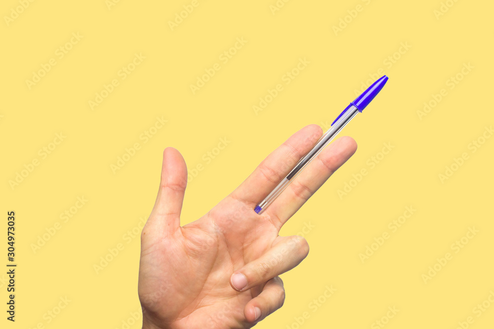 Concept of freedom of speech and information, stop censorship. Hand holding an open pen like a gun. Defend the freedom of Journalism. Yellow background Concept of freedom of speech and information, stop censorship. Hand holding an open pen like a gun. Defend the freedom of Journalism. Yellow background
