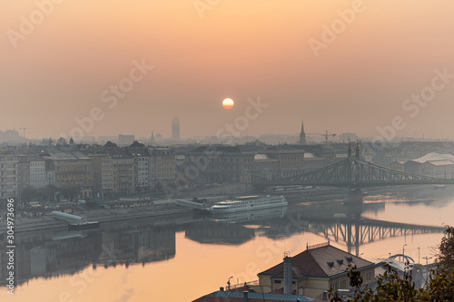 Warm sunrise image of Budapest with a Liberty bridge view and reflections in Danube river