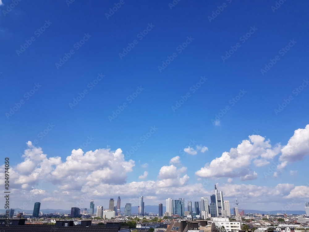 view of city with blue sky and clouds