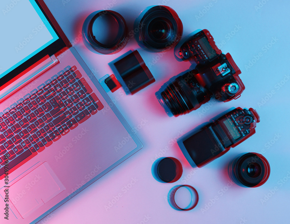 Equipment professional photographer. Laptop, camera, lenses, flashes, light  filters. Neon light. Glitch effect. Top view Stock Photo | Adobe Stock