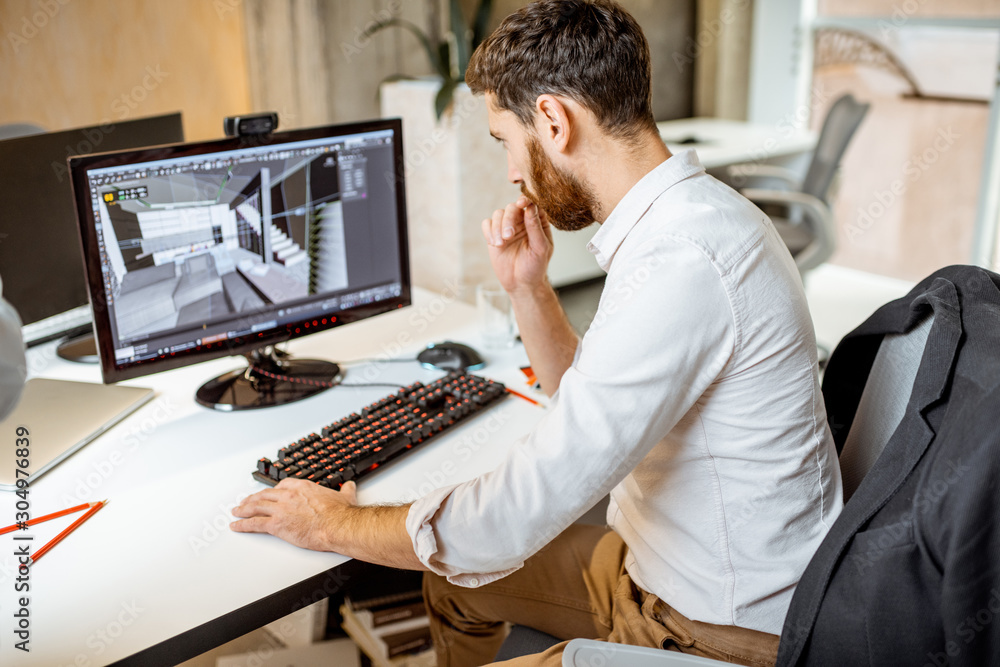 Thoughtful office employee working as an interior designer, 3d modeling on  the computer in the office Stock-Foto | Adobe Stock