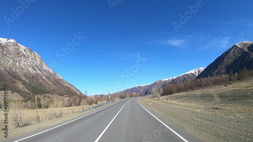 Driving along mountain asphalt road Chuysky Tract along Kurai Ridge on Altai betveen Kosh-Agach and Kurai intermountain hollows photo