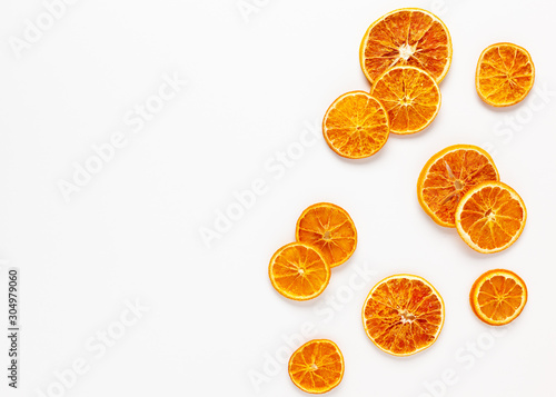  Christmas composition with dried oranges slices on white background. Natural dry food ingredient for cooking or Christmas decor for home. Flat lay.