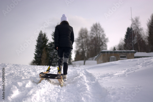 girl in the snow with sled 
