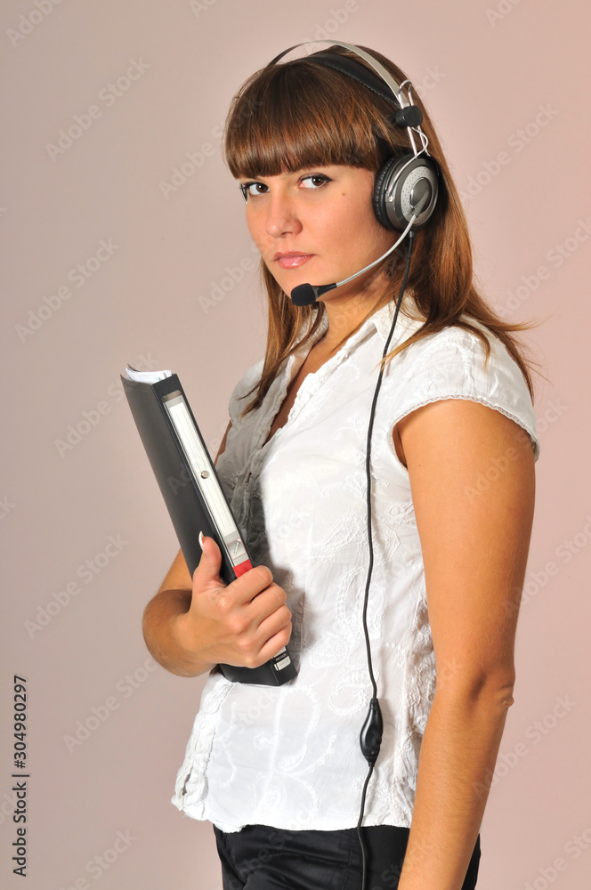 Woman posing with headphones and note book Woman posing with headphones and note book