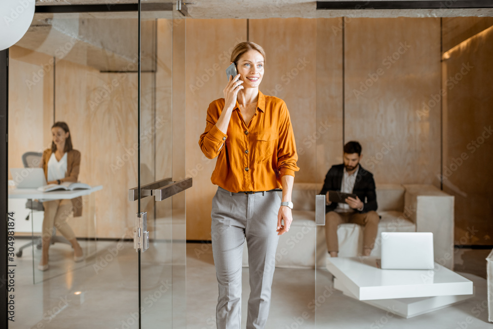 Creative people working at the marketing agency or design studio, talking phone, designing on digital tablet and working on the desktop Creative people working at the marketing agency or design studio, talking phone, designing on digital tablet and working on the desktop